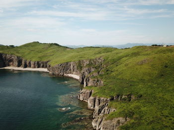 Scenic view of sea and mountains against sky