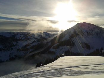 Scenic view of snowcapped mountains against sky