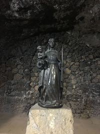 Statue against wall