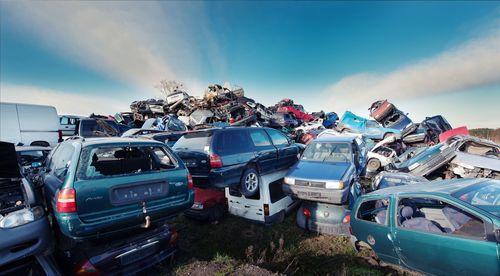 Cars parked on street against blue sky