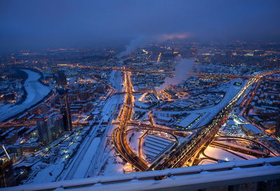High angle view of illuminated city against sky at night