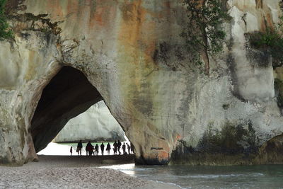 People in cave at beach