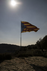 Scenic view of flag against sky