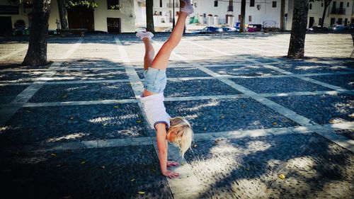 Woman playing on street in city