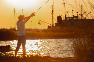 Rear view of man standing in sea