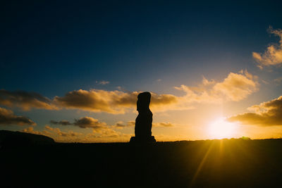 Silhouette statue against sky during sunset