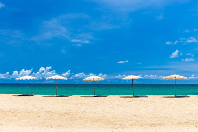 Scenic view of beach against blue sky