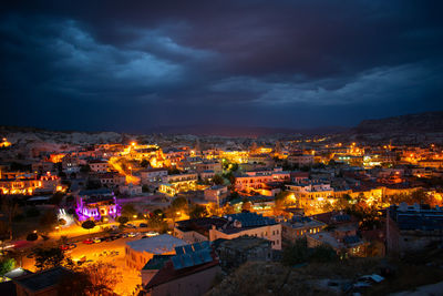 High angle view of illuminated townscape against sky at night