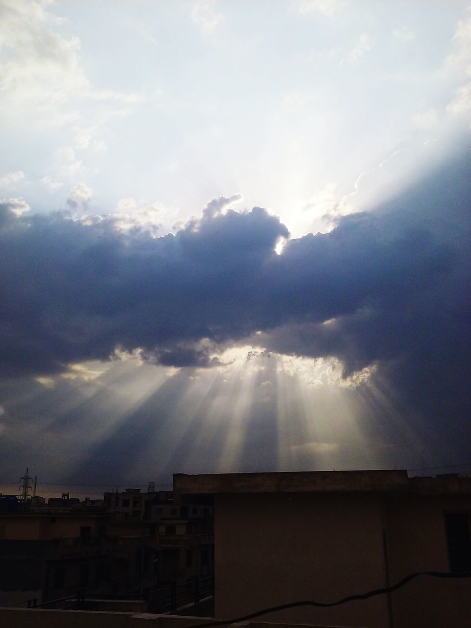 sky, building exterior, cloud - sky, architecture, built structure, sunbeam, no people, sunlight, outdoors, day, low angle view, nature, city