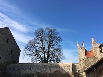 Low angle view of bell tower against sky