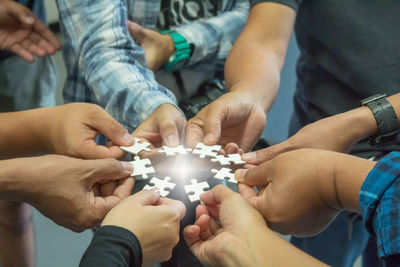 Friends holding jigsaw piece