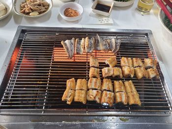 High angle view of meat on barbecue grill