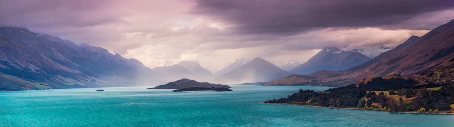Panoramic view of sea and mountains against sky
