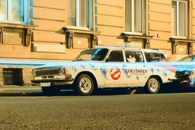 Vintage car on street against buildings