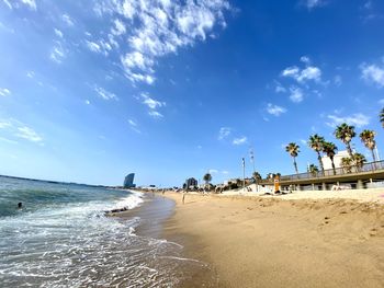 Scenic view of beach against blue sky