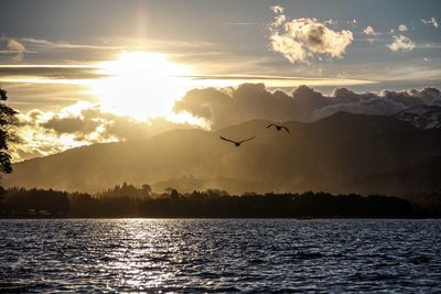 Scenic view of lake at sunset