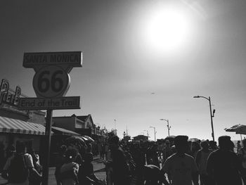 Crowd on street against clear sky