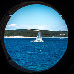 Sailboat sailing in sea against sky