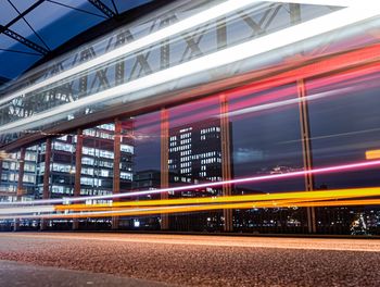 Light trails on train in city at night