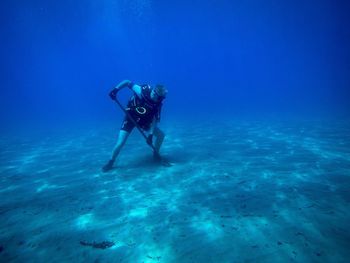 Scuba diver digging ocean floor