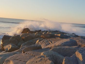 Scenic view of sea against clear sky during sunset