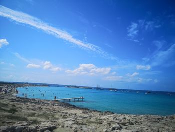 Scenic view of beach against blue sky