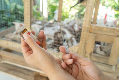 Midsection of person holding cigarette