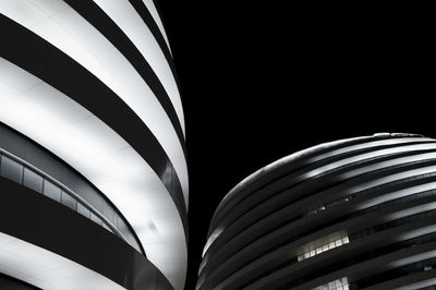 Low angle view of illuminated buildings against sky at night