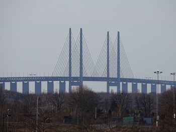 Low angle view of bridge over river against clear sky