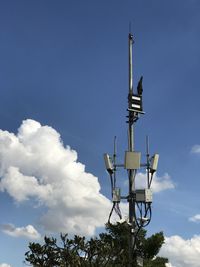 Low angle view of repeater tower against blue sky