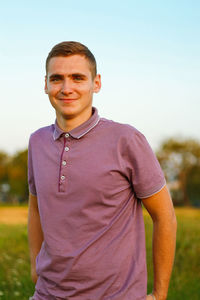 Portrait of young man standing against sky