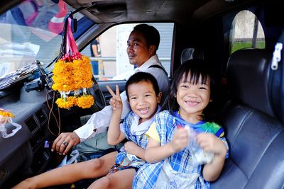 Portrait of friends sitting in car