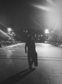 Full length of woman walking on road at night