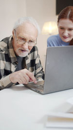 Senior man using laptop at nursing home