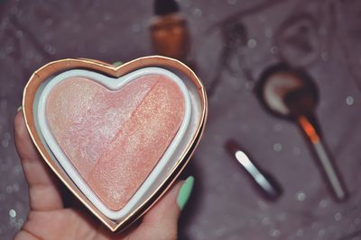 Close-up of hand holding heart shape