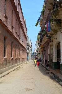 Street amidst buildings against sky in city