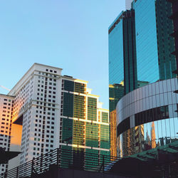 Low angle view of modern buildings against clear blue sky