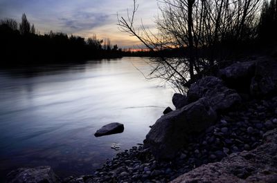 Scenic view of lake against sky at sunset