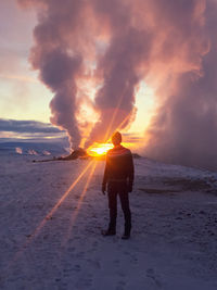 Man walking through geothermal landscape