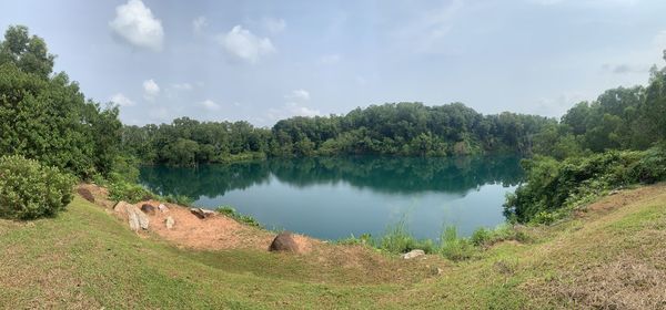 Panoramic view of lake and trees against sky