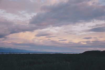 Scenic view of landscape against cloudy sky