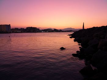 Scenic view of sea against orange sky