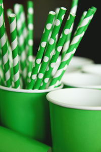 Close-up of green straws in container