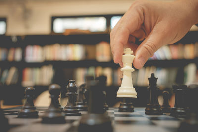 Close-up of hand playing chess