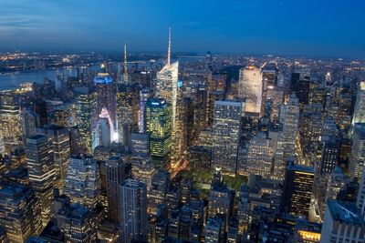 High angle view of city lit up at night