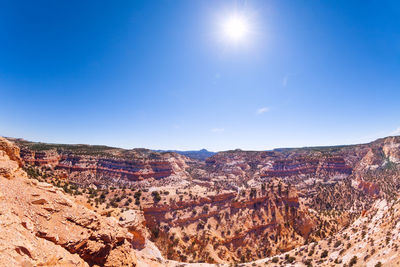 Scenic view of landscape against blue sky