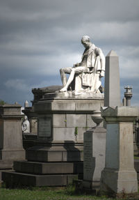 Statue against historic sky