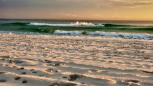 Scenic view of beach against sky during sunset