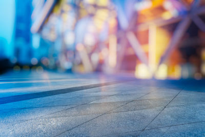 Defocused image of people walking on illuminated street