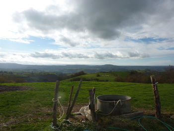 Scenic view of landscape against cloudy sky